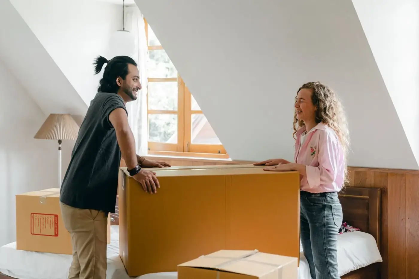 Young couple unpacking boxes in their new home